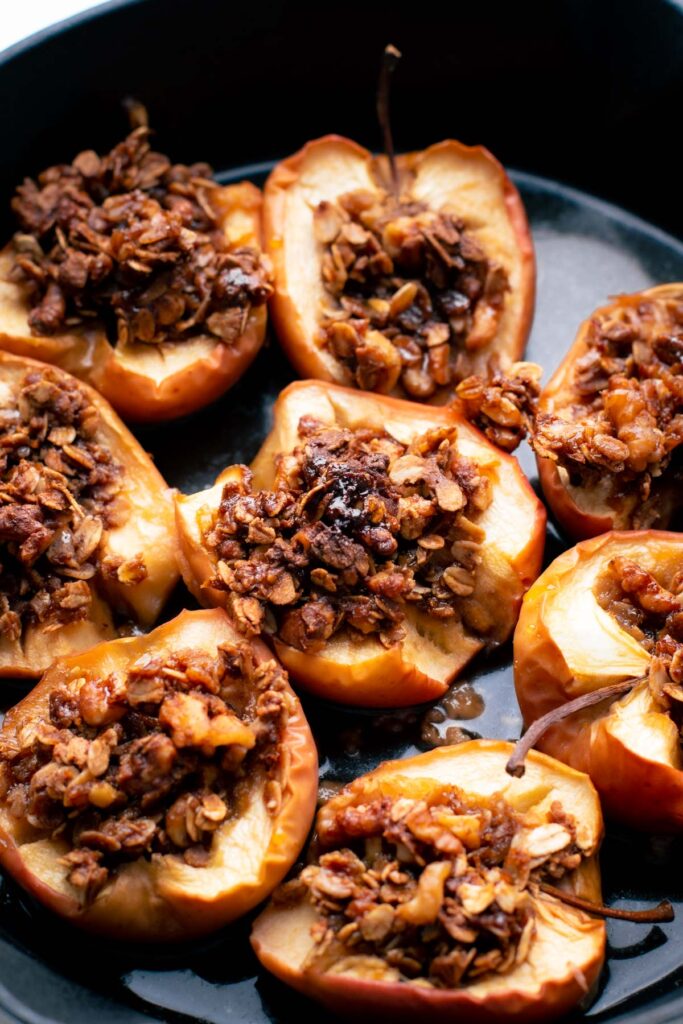 baked apples with filling in a black cast iron pan