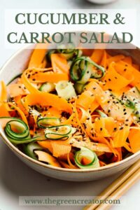 Cucumber and carrot salad sprinkled with white and black sesame seeds in a light brown bowl with a golden edge with pinterest text over the top