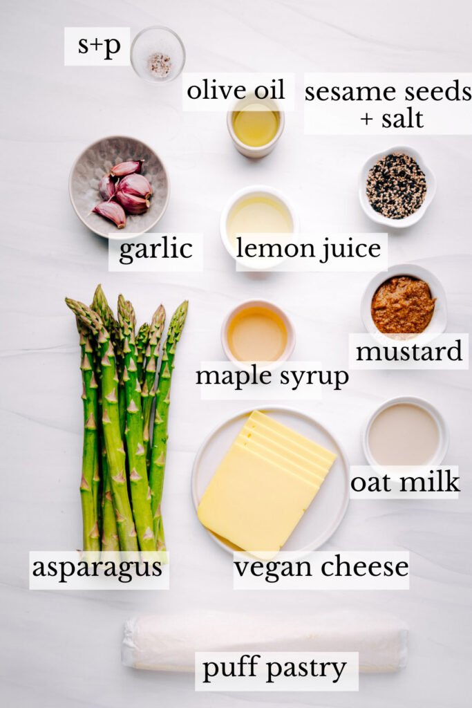 Ingredients for Asparagus with Puff Pastry on a white backdrop with the names of the ingredients next to it