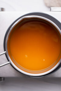 Pumpkin broth for pumpkin risotto in a stainless steel pot on a stovetop