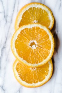 sliced oranges on marble