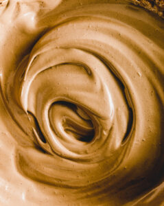 close up brown dalgona foam with a swirl