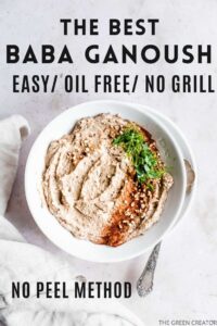 baba ganoush in a light bowl on a plate on a light background with fresh herbs, smoked paprika powder and chopped hazelnuts on top next to a light brown napkin with text for pinterest