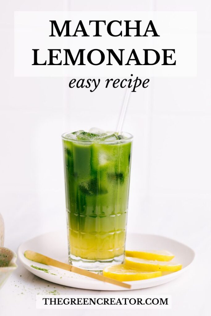 Matcha lemonade with ice cubes with a separate yellow and green layer with a glass straw on a white plate with lemon slices and a bamboo stick with the text matcha lemonade easy recipe on the top