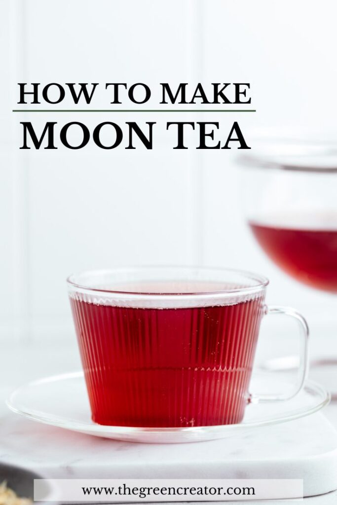 A glass teacup and plate on a white marble backdrop with red tea in it and a teapot with red tea in the background and the words how to make moon tea written on the top of the photo.
