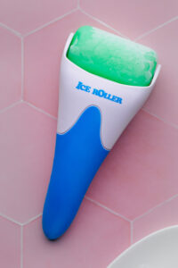 ice face roller with frozen roller on a pink tile backdrop