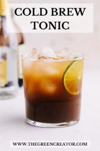 A glass with cold brew tonic with ice cubes and a slice of lime with text on the top saying cold brew tonic