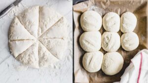 round dinner rolls batter cut in eight parts on a white backdrop with a silver knife next to dinner rolls on a lined baking sheet with parchment paper