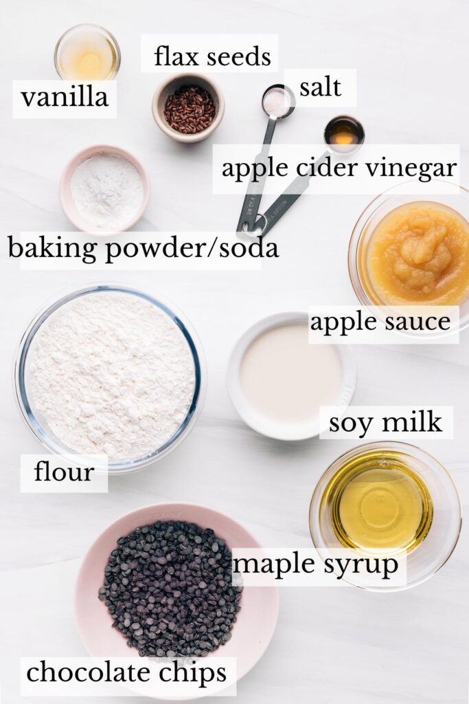 Ingredients for chocolate chip muffins on a white backdrop with the name of the ingredients next to it