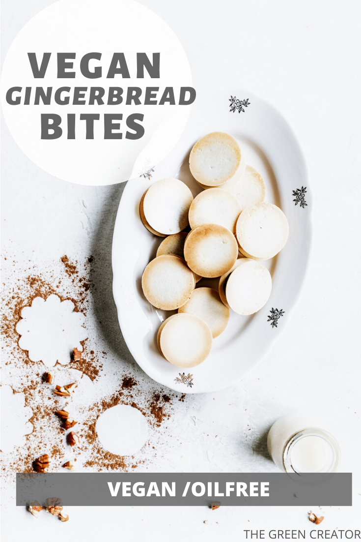 baked gingerbread bites on an oval white plate on a white backdrop with cinnamon sprinkled around
