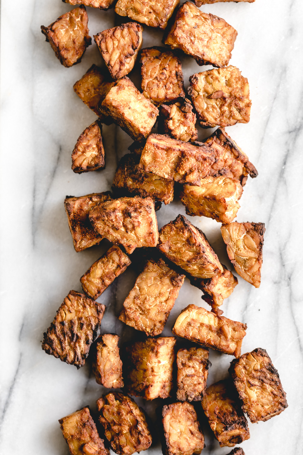 baked tempeh on a white marble backdrop