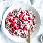 raspberry oats in bowl with wooden spoon