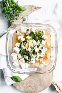 vegan feta cheese ingredients with herbs on a white napkin